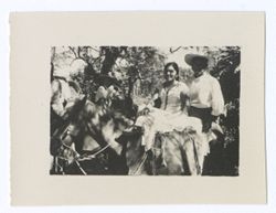 Item 1163. Two women on horseback among trees.