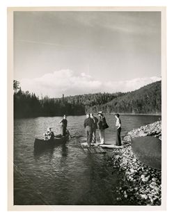 Men standing near a river bank