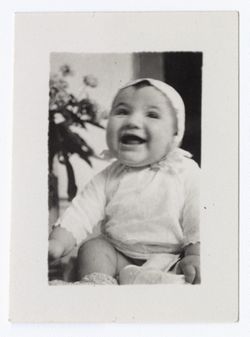 Item 1169a. Baby seen in Item 1169 above sitting alone, smiling.