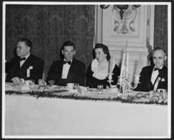 Hoagy Carmichael at banquet table with an unidentified woman and two men.