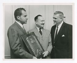 Jack R. Howard with companions and a plaque