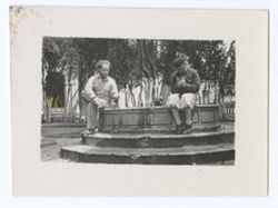 Item 1149. Eisenstein and unidentified man seated on rim of fountain in Hacienda courtyard. See also Item 410 above.