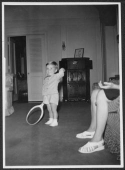 Hoagy Bix Carmichael holding tennis racket.