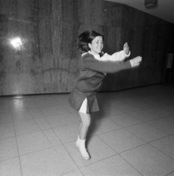 IU South Bend cheerleader practices stunt, 1970s
