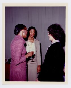 Three unidentified women talking at Mary Perry Smith's house during an event for BFHFI volunteers