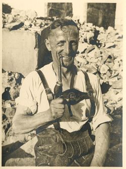 German man posing in front of ruins
