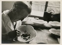 Man painting chinaware