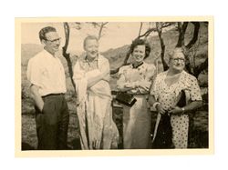 Peggy Howard and others smile in front of hills