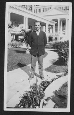Man identified as George standing in front of the Poinciana Hotel, Florida.