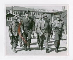Roy Howard walking with military personnel