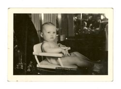 Baby sitting in a high chair