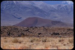 Red hill above lava field along US 395, 14 miles south of Big Pine, Calif. View is west toward Sierra