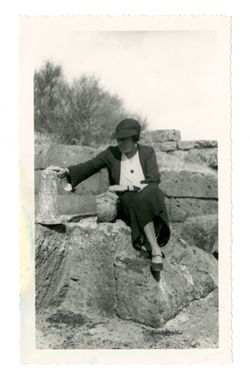 Woman sitting near ruins