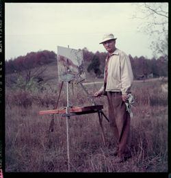 Man painting in a field