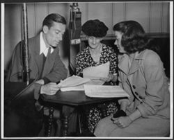Hoagy Carmichael with his mother, Lida, and an unidentified woman reading a script in front of a WFBM microphone.