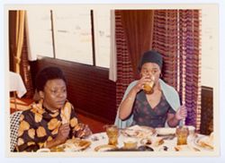 Two unidentified women at meal