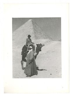 Woman on camel in front of the Great Pyramid of Giza