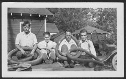 Four young men with tire inner tubes.