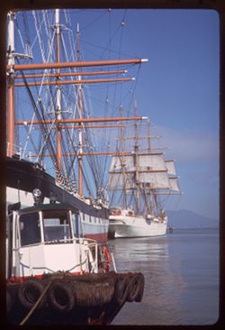 Eagle of U.S. Coast Guard lies behind schooner Balclutha