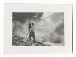 Item 1041. - 1041a. Unidentified man, possibly Kimbrough, silhouetted with camera against the sky at the top of a flight of steps, probably at the Temple of the Warriors.