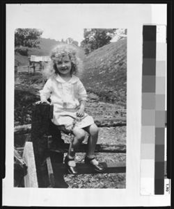Jeanne Anne Bloemker, of Indianapolis, sitting on fence
