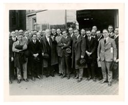 Group of men standing outside of a building
