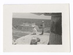 Item 1005. - 1005b. Various shots of Eisenstein with Alexandrov, Tissé and an unidentified man (separately) on the upper platform of the Castillo. Eisenstein seated or kneeling at corner of platform, other men standing behind camera. Eisenstein and unidentified man
