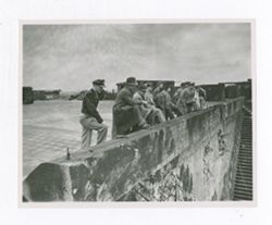 Group of men standing at a wall