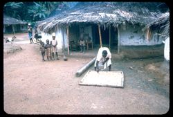 Man spreading grains on a mat