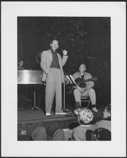 Hoagy Carmichael on stage with unidentified musicians.