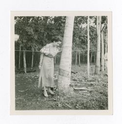 Woman standing with tree