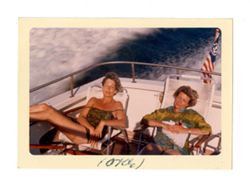Two women lounging on a speedboat
