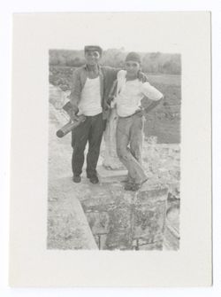 Item 1193. Two men standing side by side at edge of stone platform. Possibly taken at Chichen Itza.