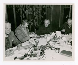Roy Howard and other men dining together