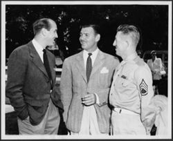 Clark Gable speaking with two unidentified men.