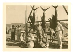 Roy Howard and companions posing with swordfish