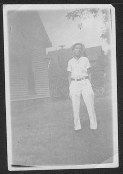 Hoagy Carmichael, standing near a house, at age 16.