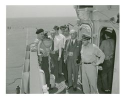 Roy W. Howard and other men on military ship