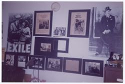Wall with photographs and posters featuring Lorenzo Tucker
