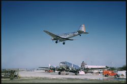 A DC-3 ARRIVES AT CHICAGO AIRPORT WhilE a BOEINg StRAtoLINER Loads up
