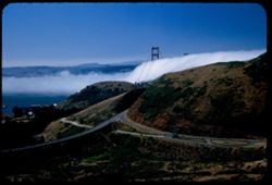 Golden Gate bridge towers above incoming fog bank. View from Waldo tunnel entrance on Marin side.