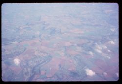 A.M. Fields of western England appear below Pan-Am jet from Los Angeles.