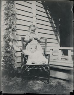 Toddler and baby in chair