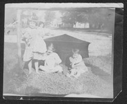 Elsa Leser, Ralph Leser, and Georgia Carmichael at age four playing outside, ca. 1909.