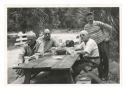 Group of men at picnic table