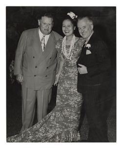 Roy W. Howard with couple at formal event