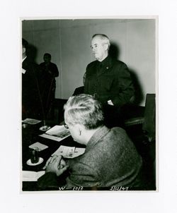Roy Howard stands in a meeting