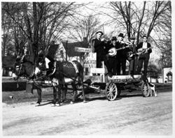 Musicians on donkey-drawn wagon