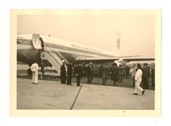 People standing in front of a Pan American airplane