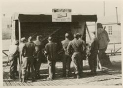 Soldiers looking at bulletin board